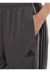 Adidas - adidas Spodnie dresowe Teamgeist adicolor JW5870 Szary Loose Fit. Kolor: szary. Materiał: syntetyk