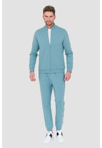 Guess - GUESS Turkusowe dresowe spodnie New Arlo. Kolor: niebieski. Materiał: dresówka
