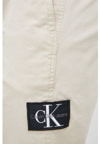 Calvin Klein Jeans spodnie męskie kolor beżowy. Kolor: beżowy. Materiał: tkanina, bawełna. Wzór: aplikacja #4