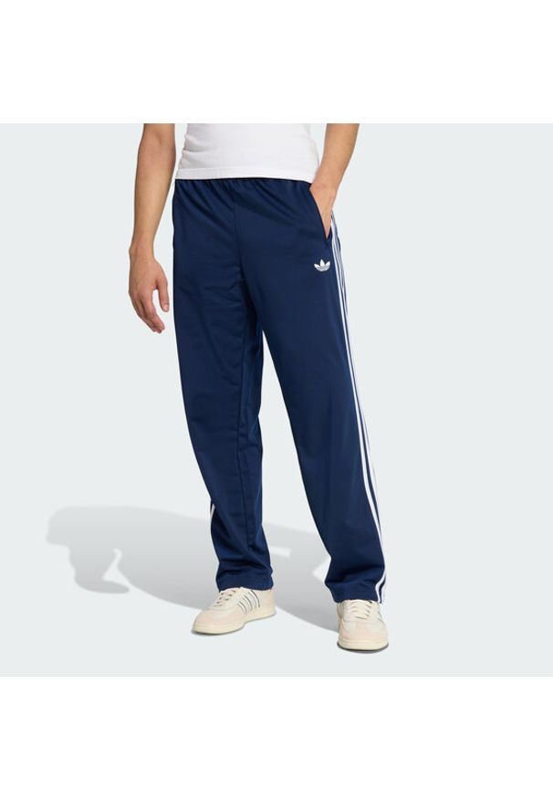 Adidas - adidas Spodnie dresowe Firebird KD8316 Granatowy Loose Fit. Kolor: niebieski. Materiał: syntetyk