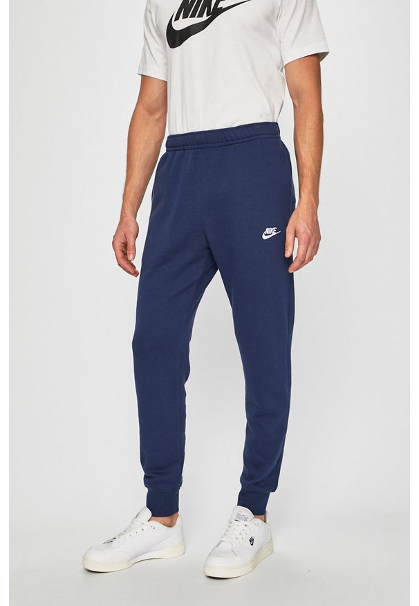 Nike Sportswear - Spodnie BV2671. Kolor: niebieski. Materiał: bawełna, poliester, materiał, dzianina. Wzór: gładki