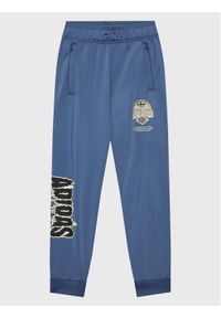 Adidas - adidas Spodnie dresowe Graphic Track HK2831 Niebieski Regular Fit. Kolor: niebieski. Materiał: syntetyk