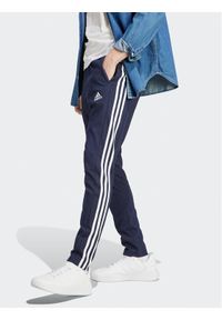 Adidas - adidas Spodnie dresowe Essentials IC0045 Granatowy Regular Fit. Kolor: niebieski. Materiał: bawełna, syntetyk