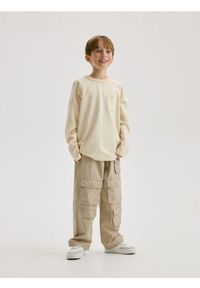 Reserved - Longsleeve oversize z kieszenią - złamana biel. Materiał: dzianina, bawełna. Długość rękawa: długi rękaw