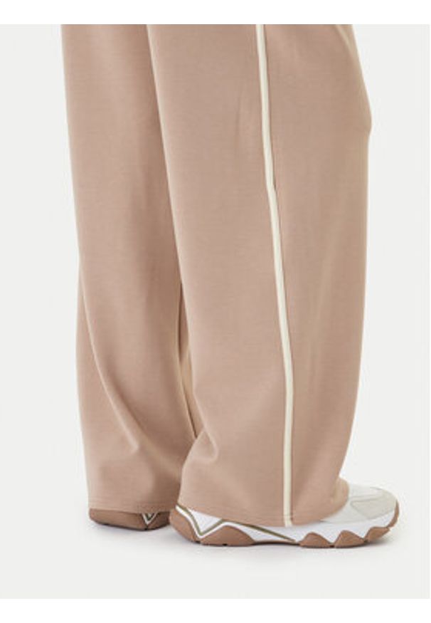 Guess Spodnie dresowe V6GB01 K2914 Beżowy Wide Leg. Kolor: beżowy. Materiał: syntetyk