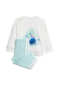 Adidas - Zestaw adidas Disney Lilo & Stitch Jogger Kids. Kolor: biały, niebieski, wielokolorowy. Wzór: motyw z bajki. Styl: młodzieżowy