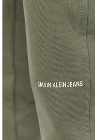 Calvin Klein Jeans - Spodnie. Kolor: zielony. Materiał: bawełna, dzianina. Wzór: gładki #3