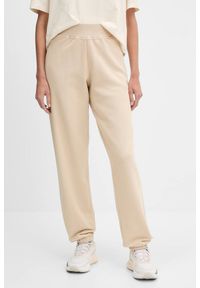 Guess - GUESS Beżowe damskie spodnie dresowe Primula, Rozmiar S. Kolor: beżowy. Materiał: dresówka #1
