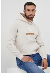 Calvin Klein Jeans bluza męska kolor beżowy z kapturem z nadrukiem. Typ kołnierza: kaptur. Kolor: beżowy. Materiał: bawełna. Wzór: nadruk