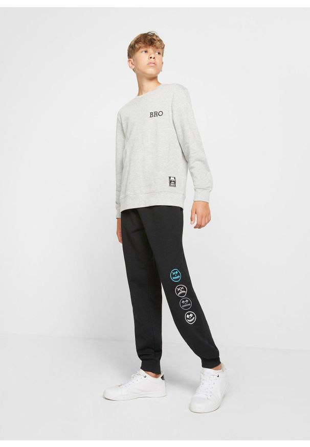 bonprix - Spodnie dresowe z miękkiej mieszanki bawełny. Kolor: czarny. Materiał: bawełna, dresówka. Wzór: nadruk