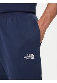 The North Face Spodnie dresowe Essential NF0A8C1F Granatowy Relaxed Fit. Kolor: niebieski. Materiał: syntetyk