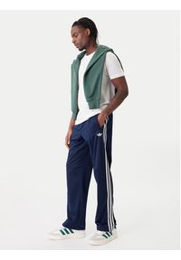 Adidas - adidas Spodnie dresowe Firebird KD8316 Granatowy Loose Fit. Kolor: niebieski. Materiał: syntetyk #5