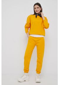 ARKK Copenhagen - Arkk Copenhagen spodnie dresowe bawełniane kolor żółty gładkie. Kolor: żółty. Materiał: bawełna, dresówka. Wzór: gładki