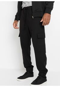 bonprix - Spodnie sportowe bojówki loose fit. Kolor: czarny. Styl: sportowy #1
