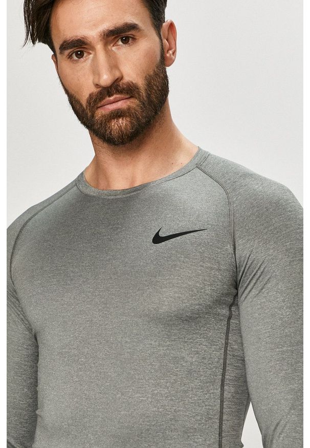 Nike - Longsleeve. Kolor: szary. Materiał: tkanina, dzianina, skóra, włókno. Długość rękawa: długi rękaw