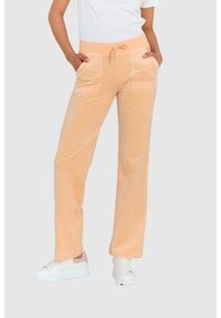 Juicy Couture - JUICY COUTURE Klasyczne welurowe spodnie dresowe del ray w brzoskwiniowym kolorze. Kolor: pomarańczowy. Materiał: dresówka, welur #1