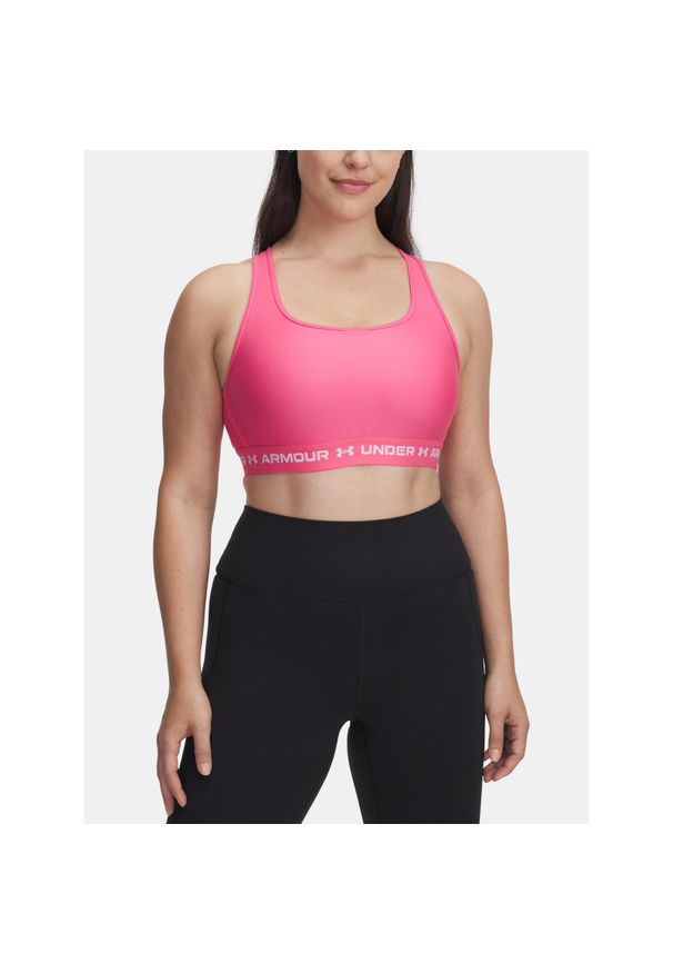 Biustonosz do jogi i pilatesu damski Under Armour Mid Crossback. Kolor: różowy. Sport: joga i pilates