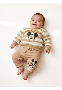 Sinsay - Spodnie dresowe Mickey Mouse - beżowy. Kolor: beżowy. Materiał: dresówka. Wzór: motyw z bajki #1