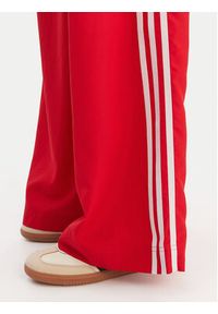 Adidas - adidas Spodnie dresowe Firebird Adilenium KD6299 Czerwony Regular Fit. Kolor: czerwony. Materiał: syntetyk #4