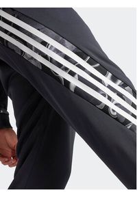 Adidas - adidas Spodnie dresowe Future Icons Allover Print IB6127 Szary Regular Fit. Kolor: szary. Materiał: syntetyk. Wzór: nadruk