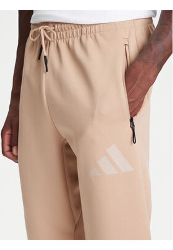Adidas - adidas Spodnie dresowe Z.N.E. JW4725 Beżowy Loose Fit. Kolor: beżowy. Materiał: bawełna