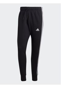 Adidas - adidas Spodnie dresowe Essentials French Terry Tapered Cuff 3-Stripes Joggers HA4337 Czarny Regular Fit. Kolor: czarny. Materiał: bawełna