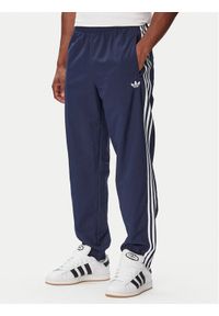 Adidas - adidas Spodnie dresowe Firebird Woven KE1370 Granatowy Regular Fit. Kolor: niebieski. Materiał: syntetyk #1