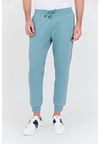 Guess - GUESS Turkusowe spodnie dresowe Aldwin. Kolor: niebieski. Materiał: dresówka