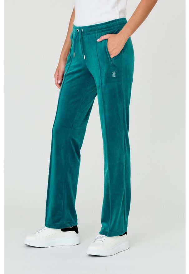 Juicy Couture - JUICY COUTURE Turkusowe spodnie Tina. Kolor: niebieski. Materiał: poliester. Wzór: aplikacja
