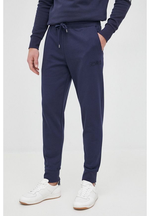 Michael Kors spodnie CR150KR4NF męskie kolor granatowy gładkie. Kolor: niebieski. Materiał: dzianina. Wzór: gładki