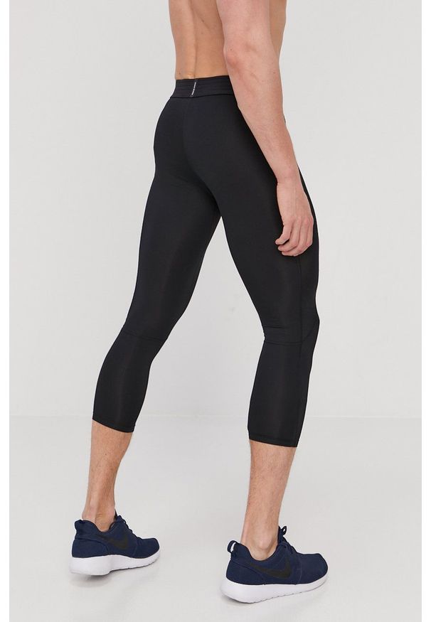 Nike Legginsy męskie kolor czarny z nadrukiem. Kolor: czarny. Materiał: dzianina, włókno, skóra, tkanina. Technologia: Dri-Fit (Nike). Wzór: nadruk