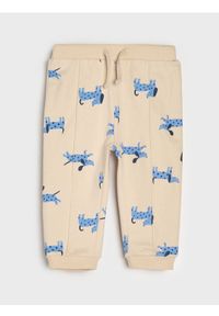 Sinsay - Spodnie jogger ze wzorem - kremowy. Kolor: kremowy #1