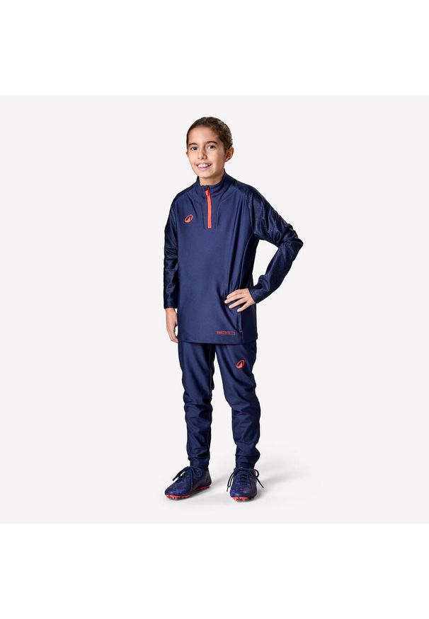 KIPSTA - Bluza piłkarska dla dzieci Kipsta Viralto Roarr na krótki suwak. Kolor: pomarańczowy, różowy, niebieski, wielokolorowy. Materiał: materiał, poliester, elastan. Długość: krótkie. Sport: piłka nożna
