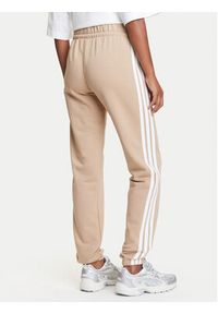 Adidas - adidas Spodnie dresowe Essentials 3-Stripes JX7661 Beżowy Regular Fit. Kolor: beżowy. Materiał: bawełna
