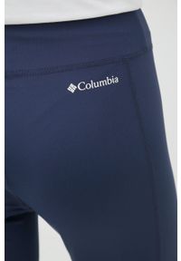 columbia - Columbia legginsy sportowe damskie kolor granatowy gładkie. Kolor: niebieski. Materiał: skóra, włókno, syntetyk. Wzór: gładki. Styl: sportowy