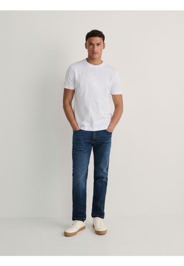 Reserved - Jeansy slim z efektem sprania - granatowy. Kolor: niebieski