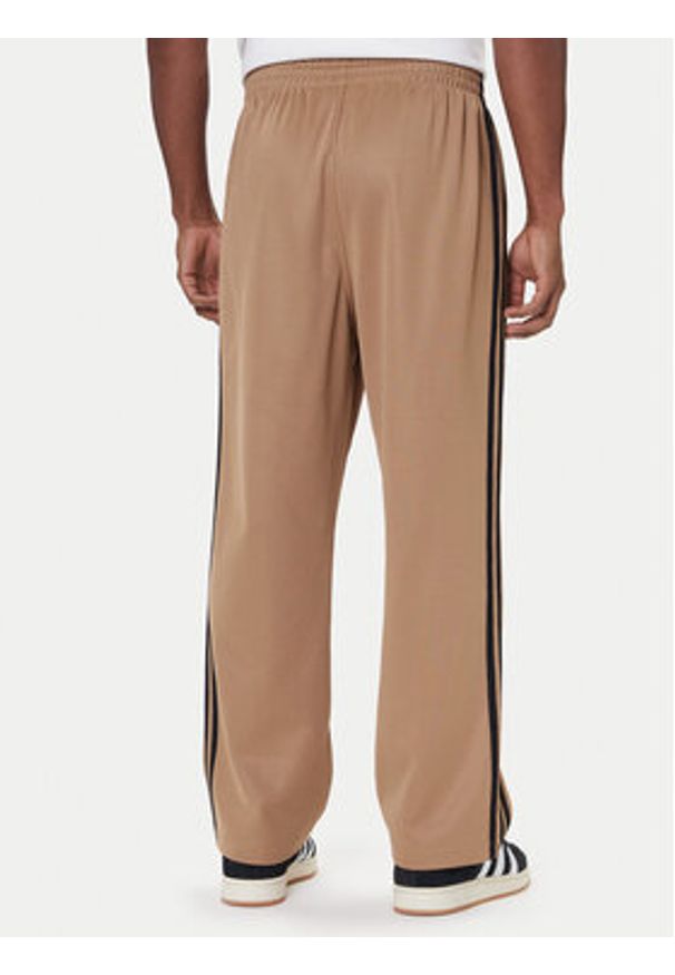 Adidas - adidas Spodnie dresowe adicolor Firebird JY1419 Beżowy Baggy Fit. Kolor: beżowy. Materiał: bawełna