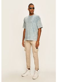 Calvin Klein Jeans - Spodnie. Kolor: beżowy. Materiał: tkanina, bawełna, elastan. Wzór: gładki #2
