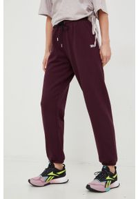 DKNY - Dkny spodnie dresowe damskie kolor fioletowy gładkie. Kolor: fioletowy. Materiał: dresówka. Wzór: gładki