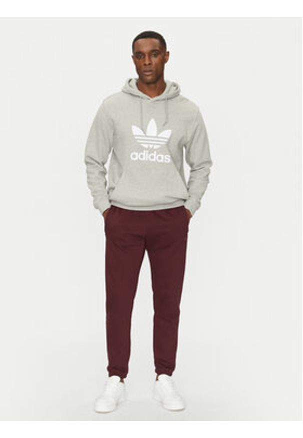 Adidas - adidas Spodnie dresowe Trefoil Essentials JD2420 Bordowy Slim Fit. Kolor: czerwony. Materiał: syntetyk, bawełna