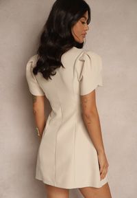 Renee - Beżowa Sukienka w Stylu Retro Zdobiona Bufiastymi Rękawami i Broszką Tiazelle. Okazja: na randkę. Typ kołnierza: dekolt w kształcie V. Kolor: beżowy. Wzór: aplikacja. Styl: retro #5