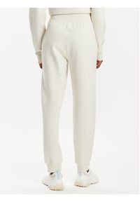 Asics Spodnie dresowe Logo 2032C844 Beżowy Regular Fit. Kolor: beżowy. Materiał: bawełna #4