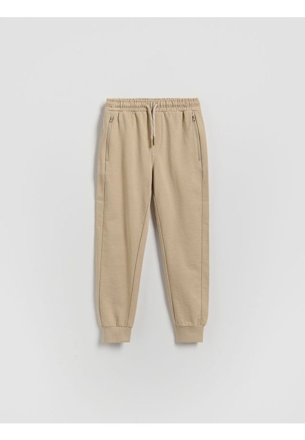 Reserved - Bawełniane joggery - beżowy. Kolor: beżowy. Materiał: bawełna