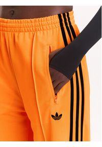 Adidas - adidas Spodnie dresowe adicolor Classic Firebird JY2694 Żółty Loose Fit. Kolor: żółty. Materiał: syntetyk #5