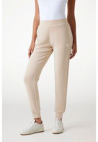 Guess - GUESS Spodnie damskie dresowe w kolorze taupe Olympe. Kolor: beżowy. Materiał: dresówka