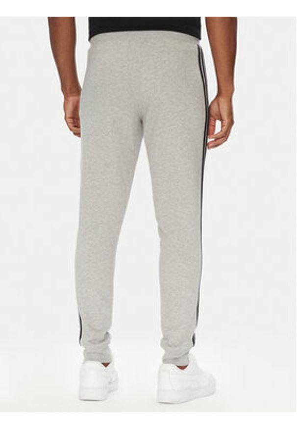 Adidas - adidas Spodnie dresowe adicolor 3-Stripes JY1387 Szary Slim Fit. Kolor: szary. Materiał: bawełna, syntetyk