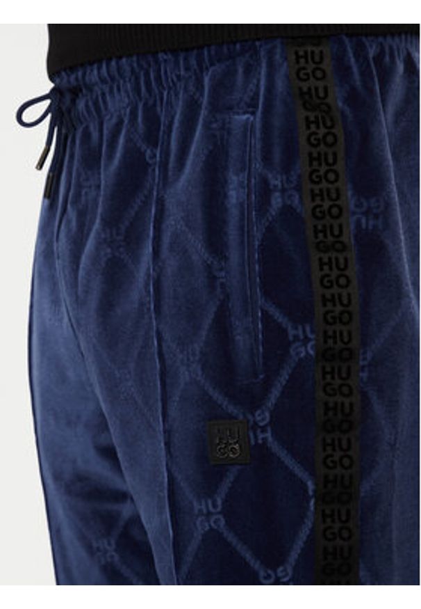 Hugo - HUGO Spodnie dresowe Dislaco 50522512 Granatowy Relaxed Fit. Kolor: niebieski. Materiał: syntetyk