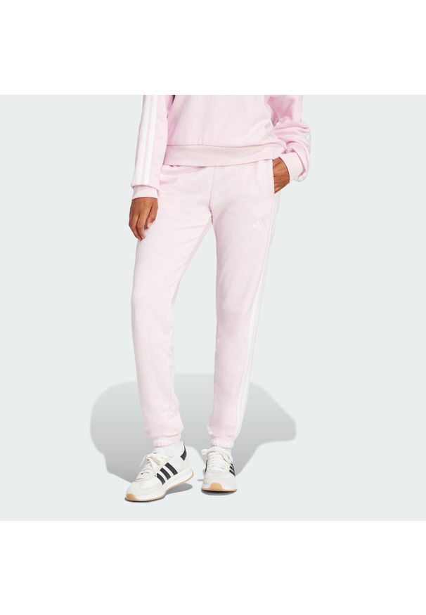 Adidas - Spodnie Essentials 3-Stripes French Terry Cuffed. Kolor: różowy, biały, wielokolorowy. Materiał: materiał. Sport: fitness