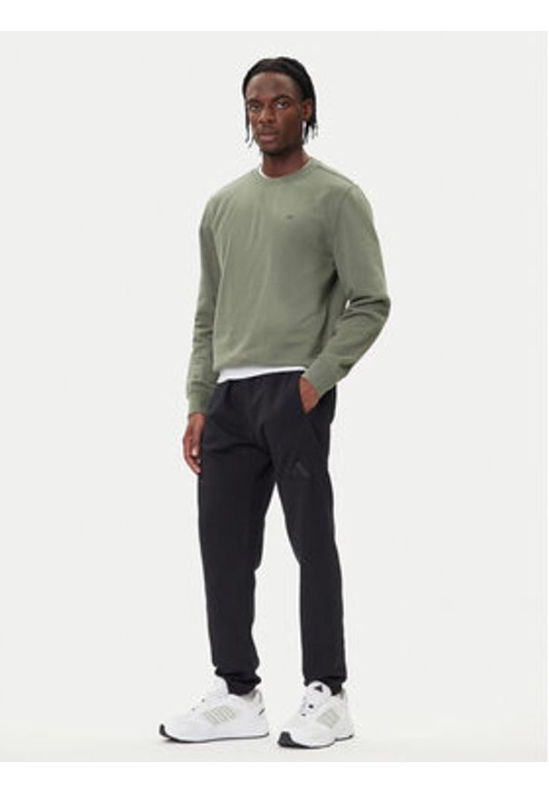 Adidas - adidas Spodnie dresowe ALL SZN Fleece IX1246 Czarny Tapered Leg. Kolor: czarny. Materiał: bawełna