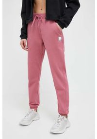 Adidas - adidas spodnie dresowe kolor pomarańczowy gładkie. Kolor: pomarańczowy. Materiał: dresówka. Wzór: gładki #1